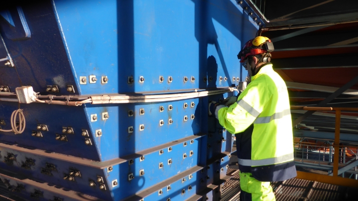 LKAB employee worker working on a huge blue chute. 